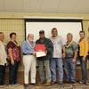 Grantee Dan Kahuanui receives graduation certificate for farming